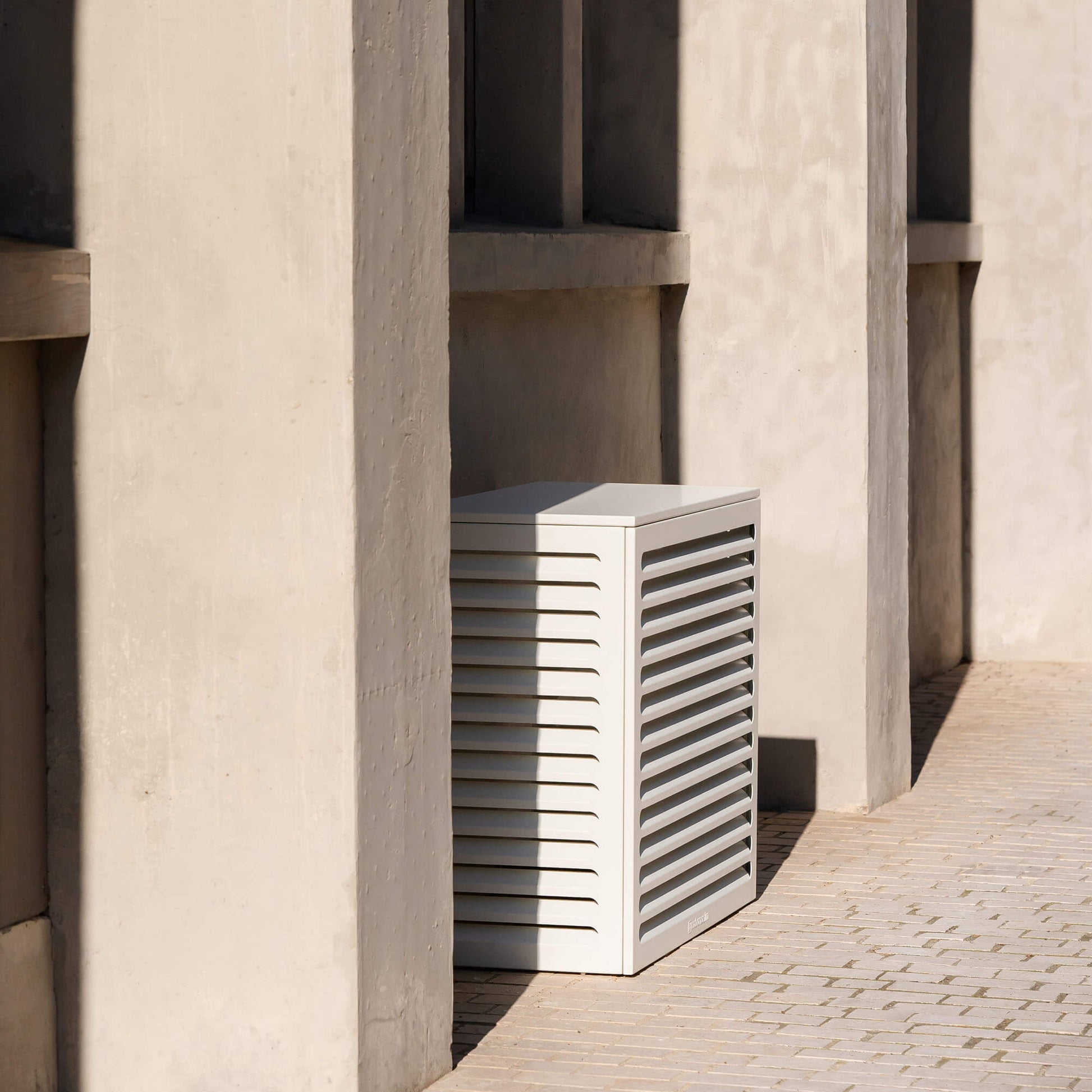 Cache clim blanc (RAL 9010) – taille M, installé avec soin – vue style architecture. Protection élégante et durable, pensée pour s’intégrer à tous les environnements extérieurs. Un cache clim design pensé pour durer.